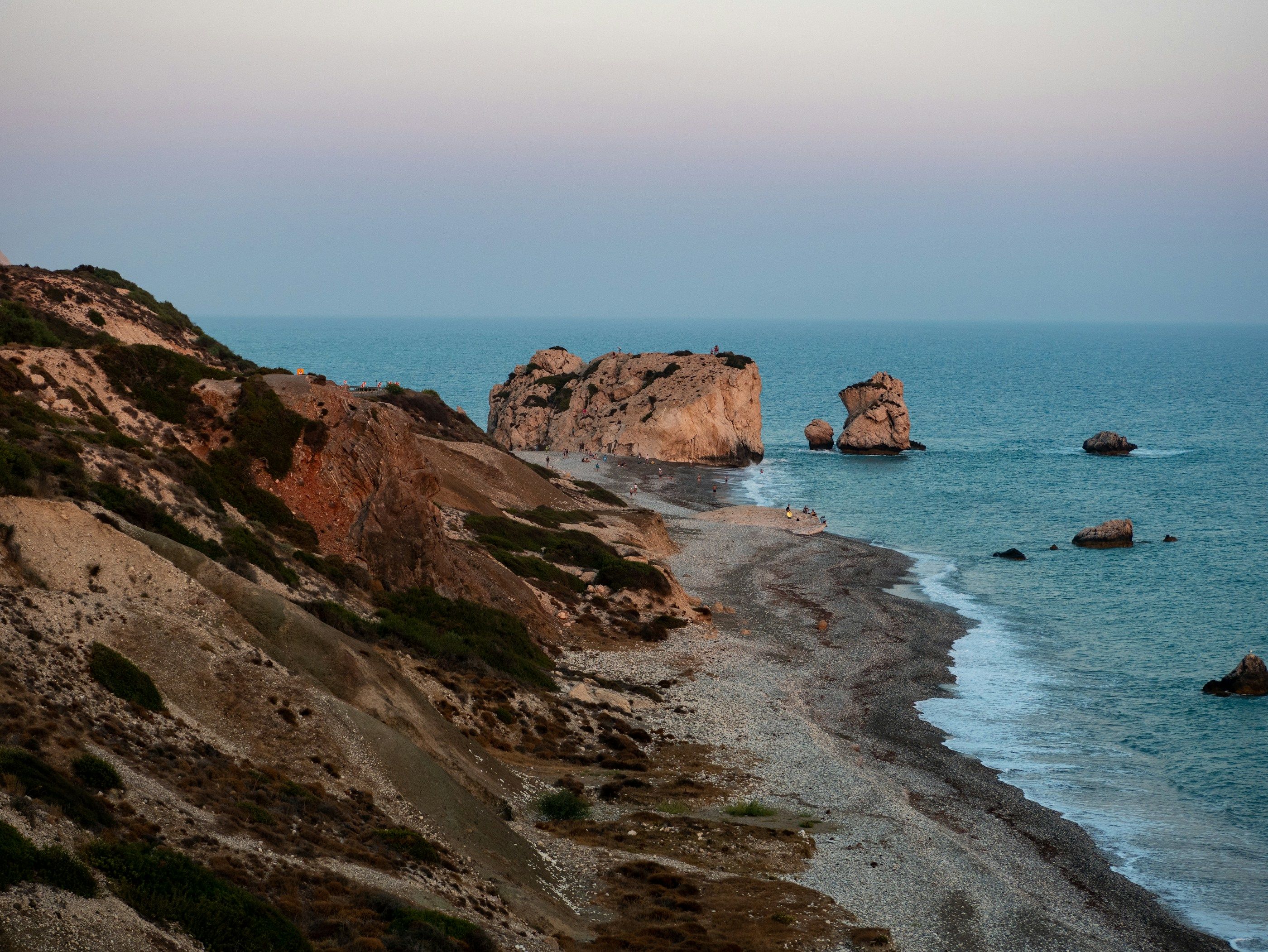 The coastline at Petra tou Romiou, with pale cliffs running down to the sea.